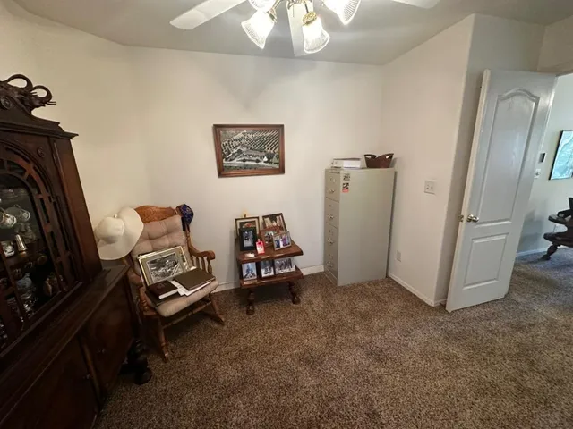 a view of a room with workspace and a window