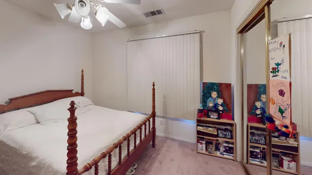 a bedroom with bed and a chandelier