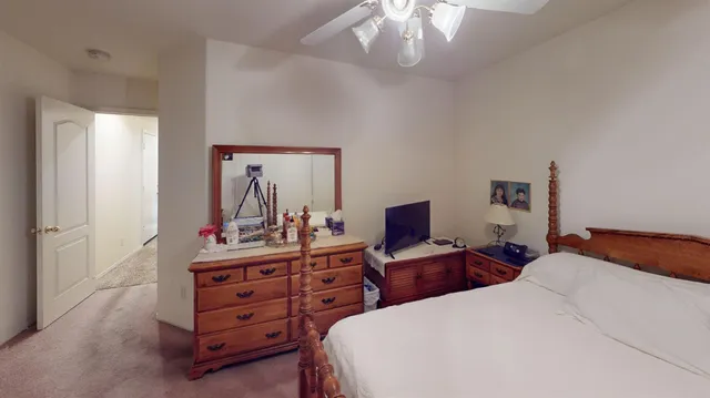 a bedroom with a bed and a chandelier