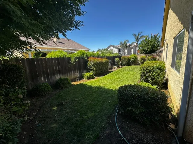 a backyard of a house with yard and outdoor seating