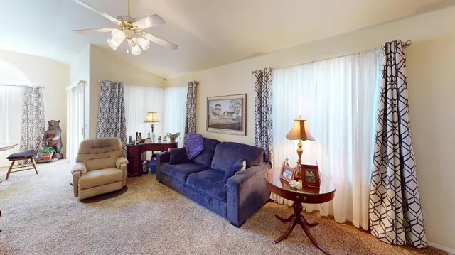 a living room with furniture and a chandelier