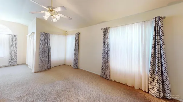 a view of a livingroom with a chandelier fan