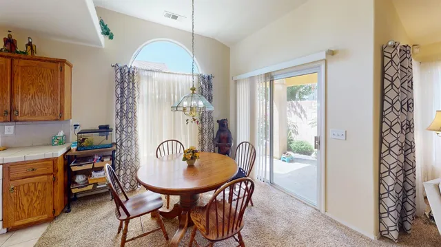 a dining room with furniture a chandelier and window