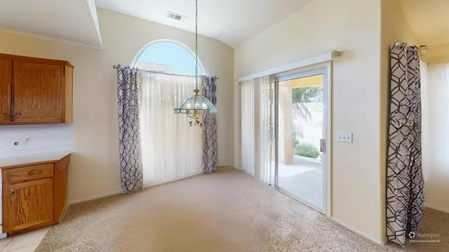 a view of a room with a door and wooden floor