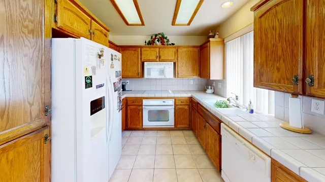 a kitchen with stainless steel appliances granite countertop a sink and a stove