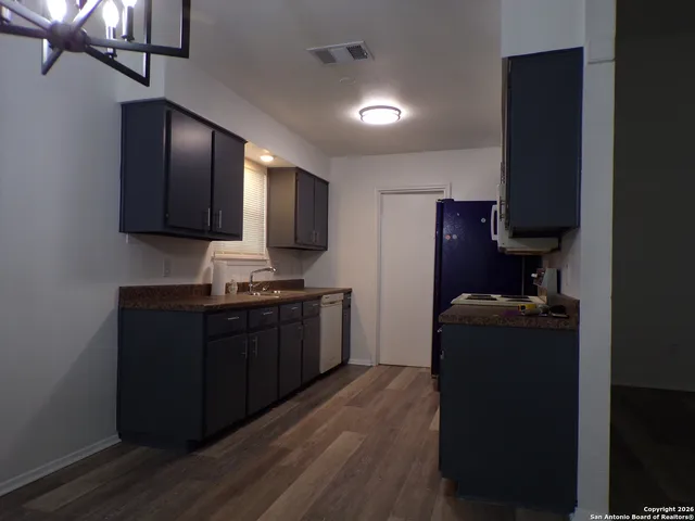 a kitchen with a refrigerator stove and sink