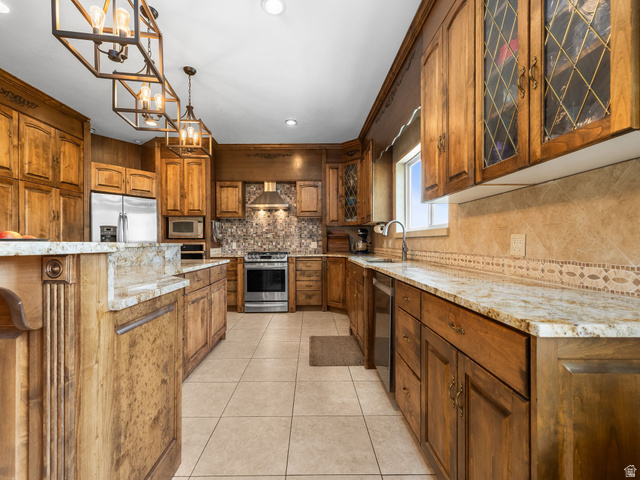 1317 South Pond Circle Mapleton, UT 84664 - Photo 8 of 63 Spacious kitchen featuring extensive wood cabinetry, granite countertops, stainless steel appliances, a tiled backsplash, and recessed lighting