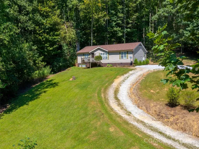 a view of a house with a yard table and chairs