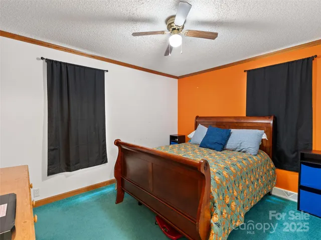 a bed sitting in a room next to a window