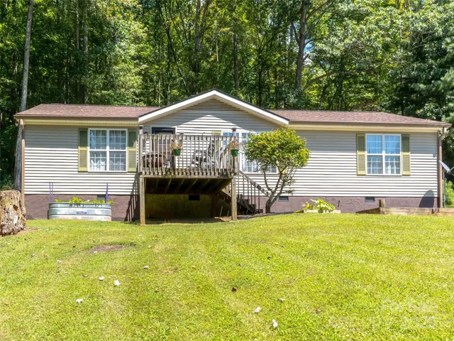 a view of a house with a yard patio and a swimming pool