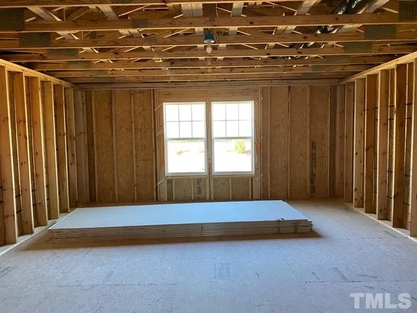 a bedroom with a bed and curtain