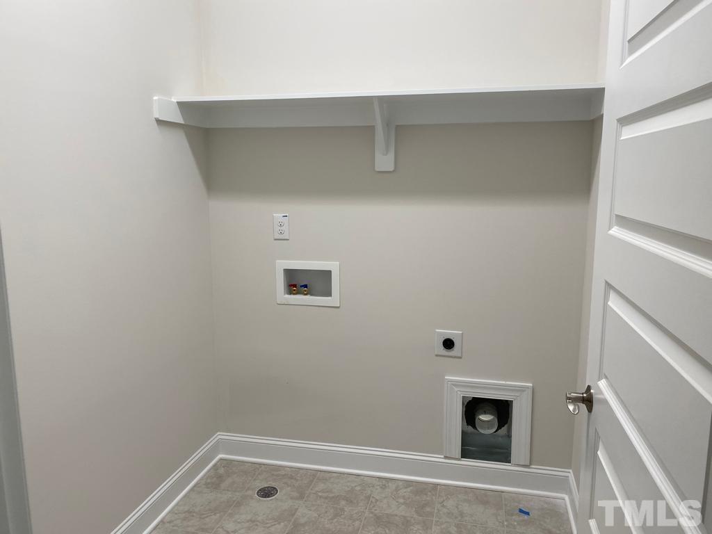 1185 St Cloud Loop Apex, NC 27523 - Photo 14 of 18 a room with a fireplace and a view of bedroom