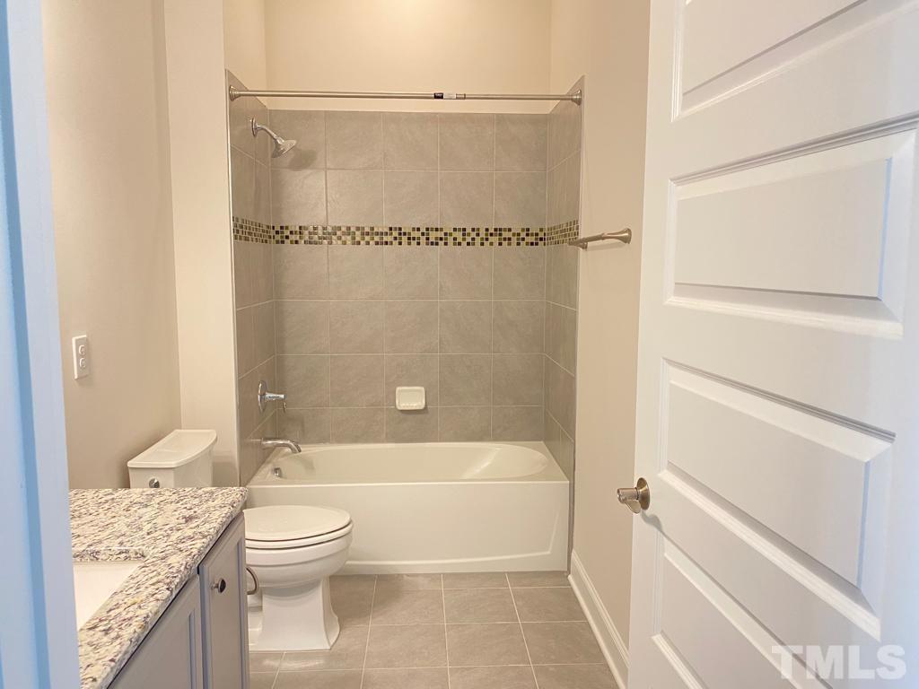 1185 St Cloud Loop Apex, NC 27523 - Photo 17 of 18 a bathroom with a toilet and a shower