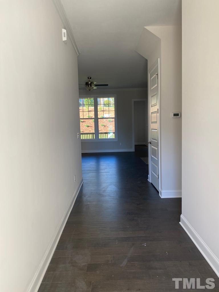 1185 St Cloud Loop Apex, NC 27523 - Photo 2 of 18 an empty room with wooden floor and windows