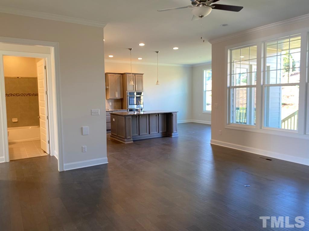 1185 St Cloud Loop Apex, NC 27523 - Photo 3 of 18 an empty room with wooden floor and windows