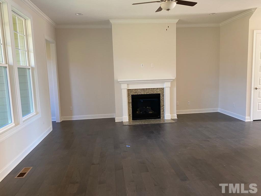 1185 St Cloud Loop Apex, NC 27523 - Photo 6 of 18 a view of an empty room with a fireplace and a window