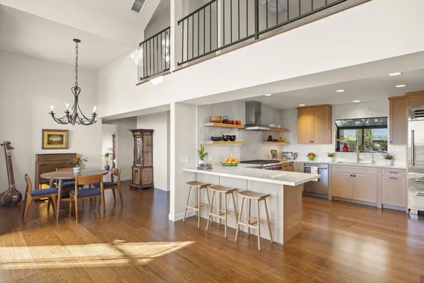 a kitchen with stainless steel appliances granite countertop a sink and cabinets