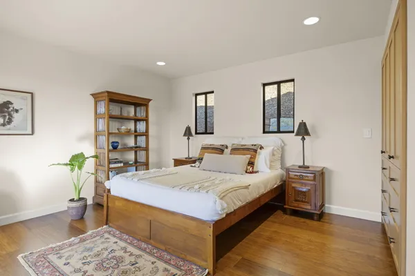 a bedroom with a large window and a bed