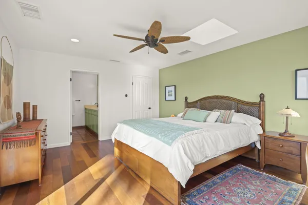 a living room with a floor to ceiling window and outdoor seating