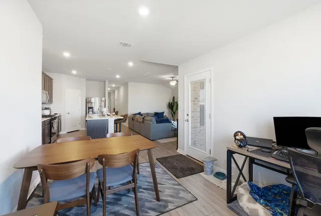 a view of a dining room with furniture and wooden floor