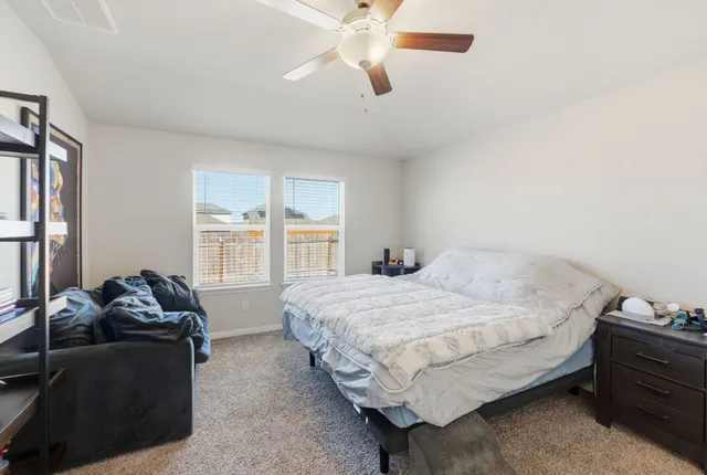 a bathroom with a granite countertop sink a toilet and a mirror