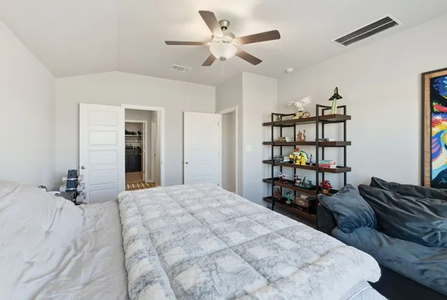 a bedroom with bed couch and window