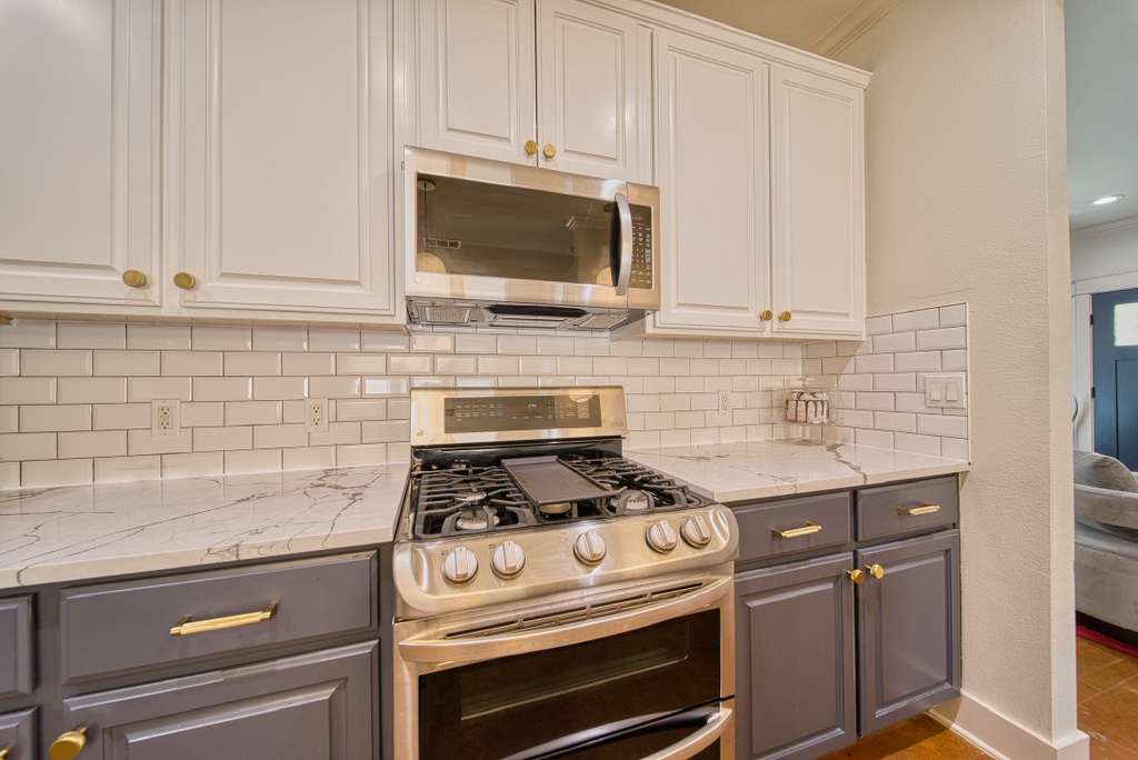 4113 Camacho Street Austin, TX 78723 - Photo 12 of 36 a kitchen with microwave cabinets and stove top oven