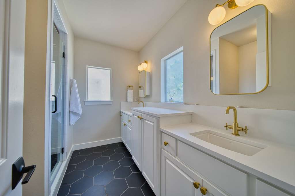 4113 Camacho Street Austin, TX 78723 - Photo 21 of 36 a bathroom with a double vanity sink mirror and