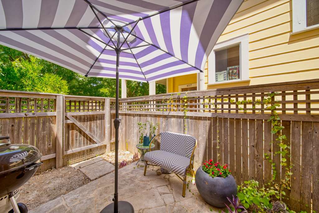 4113 Camacho Street Austin, TX 78723 - Photo 31 of 36 a view of a chair tables and chairs under an umbrella