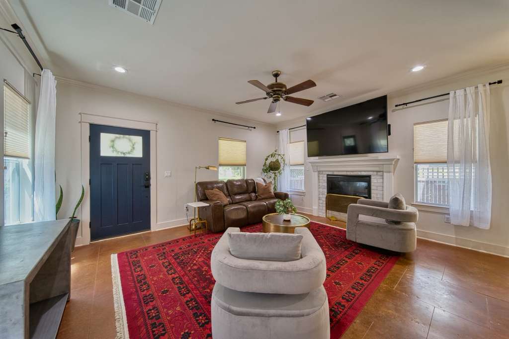 4113 Camacho Street Austin, TX 78723 - Photo 6 of 36 a living room with furniture a fireplace and a flat screen tv