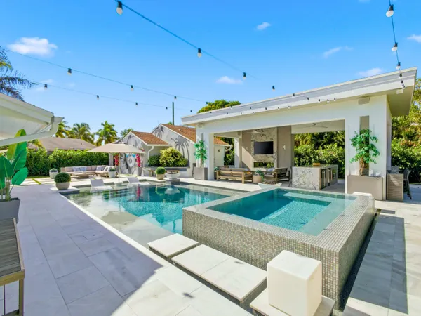 a view of a patio with swimming pool table and chairs