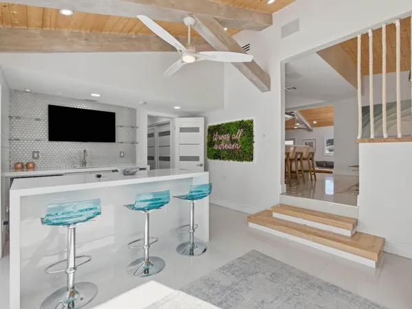 a living room with furniture and kitchen view