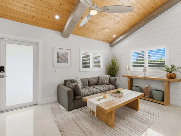 a spacious bedroom with a bed a window and a dresser