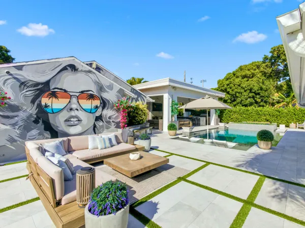 a view of a house with swimming pool and sitting area