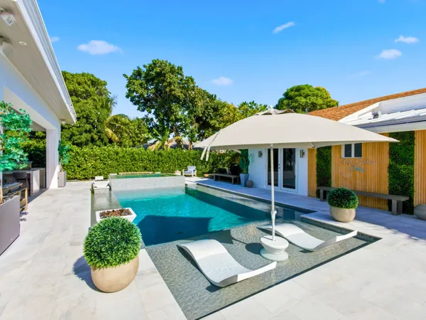 a outdoor living space with furniture potted plant and a large window