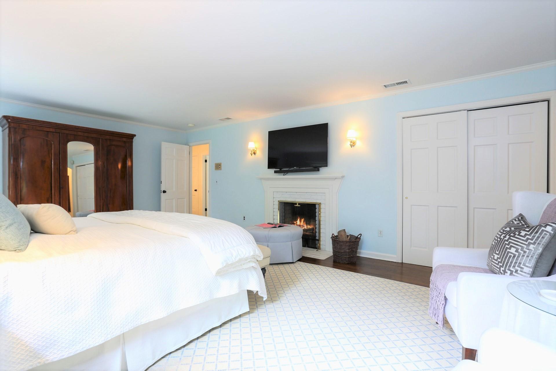 107 Inwood Road Darien, CT 06820 - Photo 22 of 40 a spacious bedroom with a bed and a flat screen tv