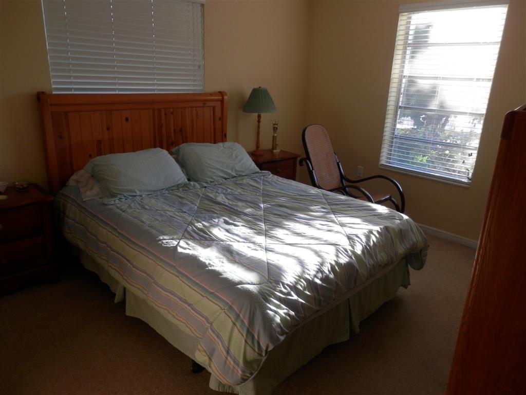 6311 Southwest 93rd Court Miami, FL 33173 - Photo 7 of 9 a bed sitting in a bedroom next to a window