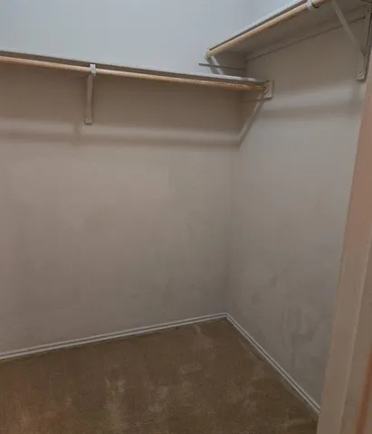 a view of an empty walk in closet
