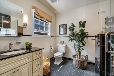 a bath room with a sink and a wooden floor