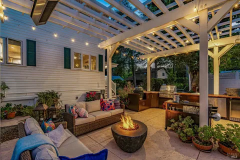 a living room with patio furniture and a potted plant