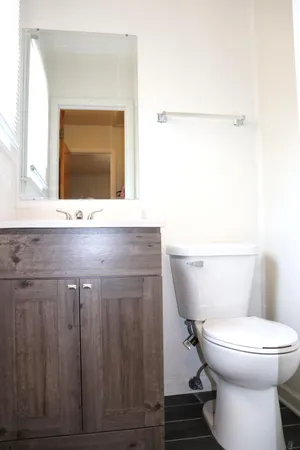 a bathroom with a toilet a sink and mirror