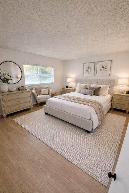 9374 Southwest 3rd Street, Unit 714 Boca Raton, FL 33428 - Photo 11 of 21 a spacious bedroom with a bed a couch and dresser