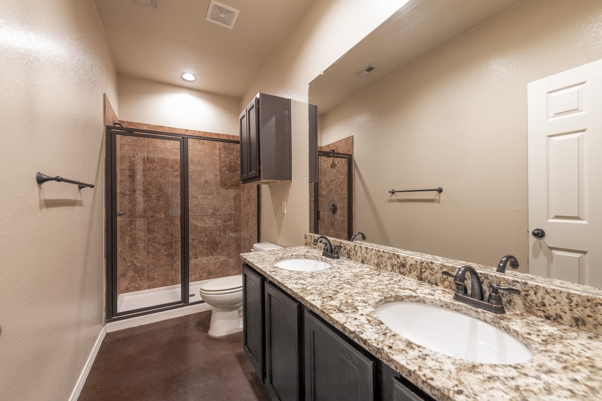 424 Jack Rabbit Lane, Unit B Buda, TX 78610 - Photo 13 of 20 a bathroom with a granite countertop sink and a mirror