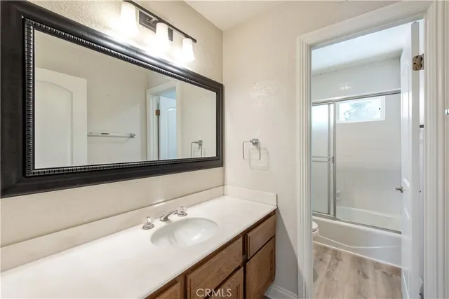 a bathroom with a shower a toilet and a glass window