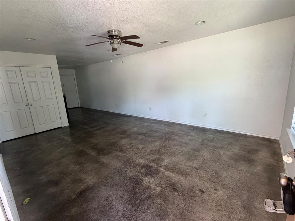 712 Seven Oaks Road, Unit 712 Bonham, TX 75418 - Photo 2 of 14 an empty room with a ceiling fan and carpet
