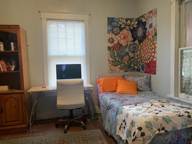 a bedroom with a bed and a window