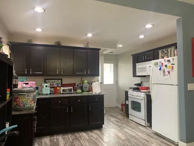 a kitchen with stainless steel appliances granite countertop a refrigerator sink and stove