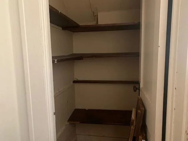 a bedroom with a bed and a dresser in it