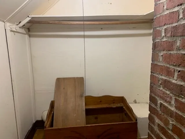 a bedroom with a bed a window and dresser