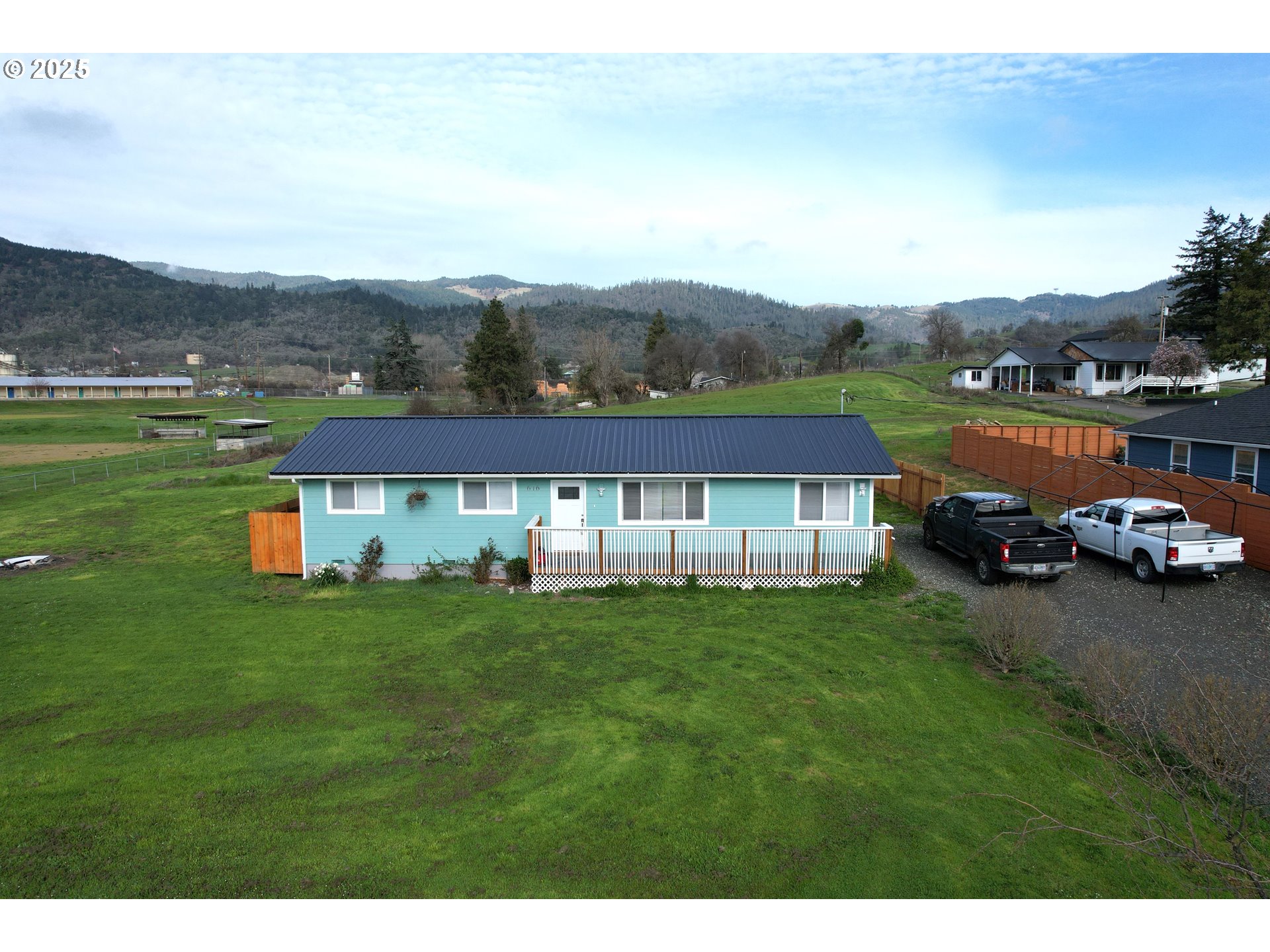 616 4th Avenue Riddle, OR 97469 - Photo 1 of 36 a view of a house with a big yard and a large tree